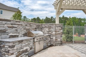 A stone wall with a grill on it.