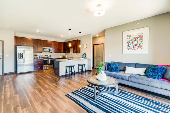 a living room with a couch and a kitchen