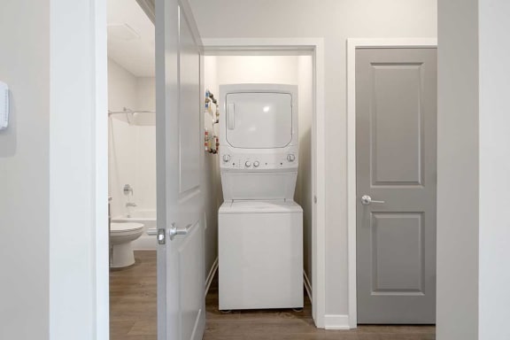 a stackable washer and dryer in a closet