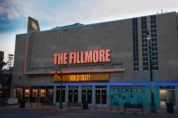 a large building with a neon sign that reads the fillmore