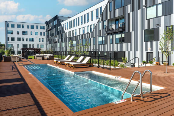 a rendering of a swimming pool in front of a building