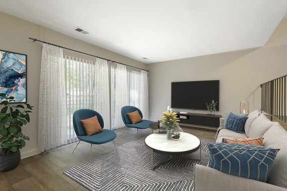 a living room with a white couch and two blue chairs at Copper and Quarry Village, Pikesville, MD, 21209