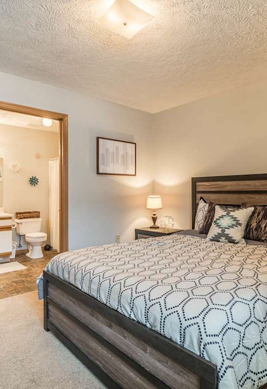  bedroom with a large bed and attached bathroom