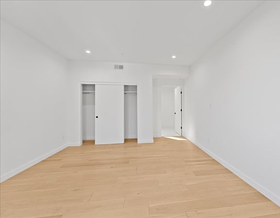 A room with wooden floors and white walls.