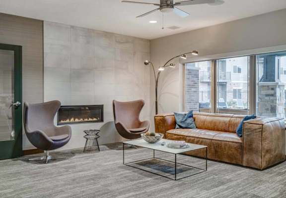 a living room with a couch and chairs and a fireplace