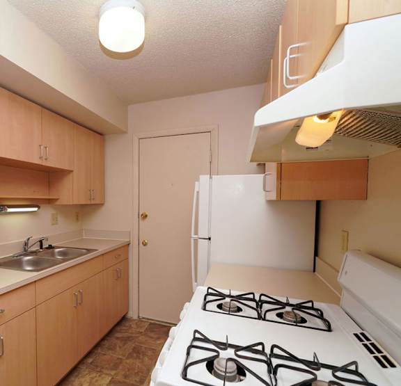 a kitchen with a closet and a stove and a sink at Madeira Apartments, Kalamazoo, MI, 49001
