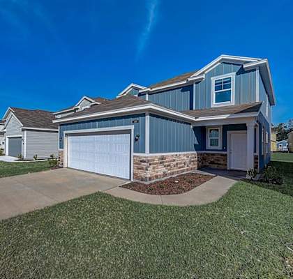 a home with a blue siding and a blue garage door