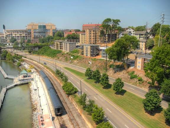 A train is on the tracks near a body of water.at Maplehurst Apartments, Tennessee