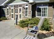 Thumbnail 4 of 8 - A chair is in front of a house.