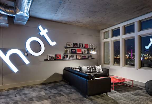 A room with a neon sign that says hot.