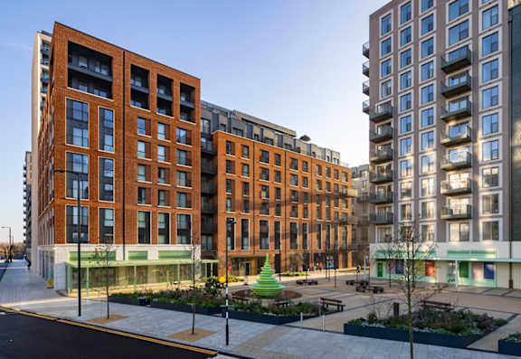 A modern apartment complex with a mix of brick and glass facades.