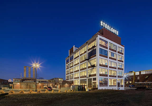A Steelcote building is lit up at night.