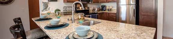 a kitchen with granite counter tops and stainless steel appliances