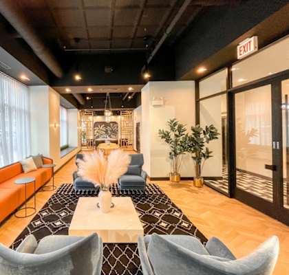 a living room with couches and chairs and a table