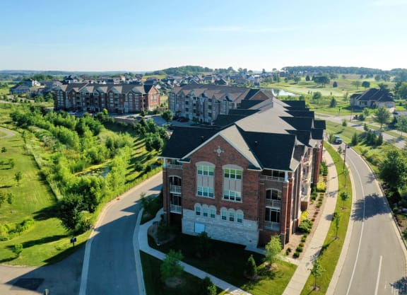 an aerial view of a large brick building next to a road
