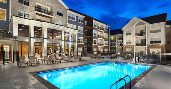 a swimming pool in the middle of an apartment building