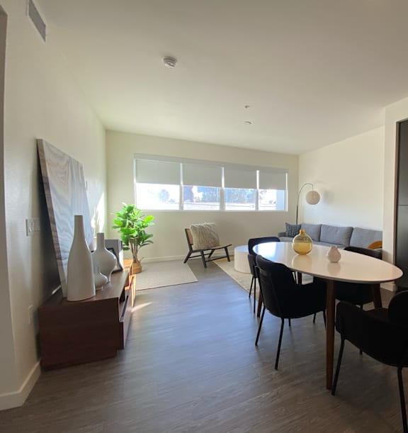 A modern dining room with a round table and chairs.