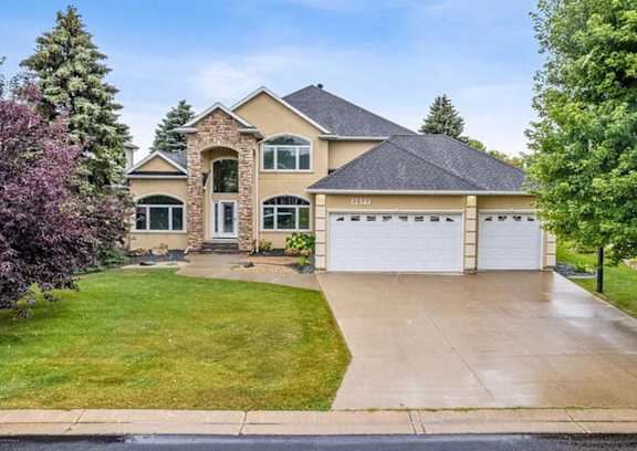 a house with a driveway and a garage door