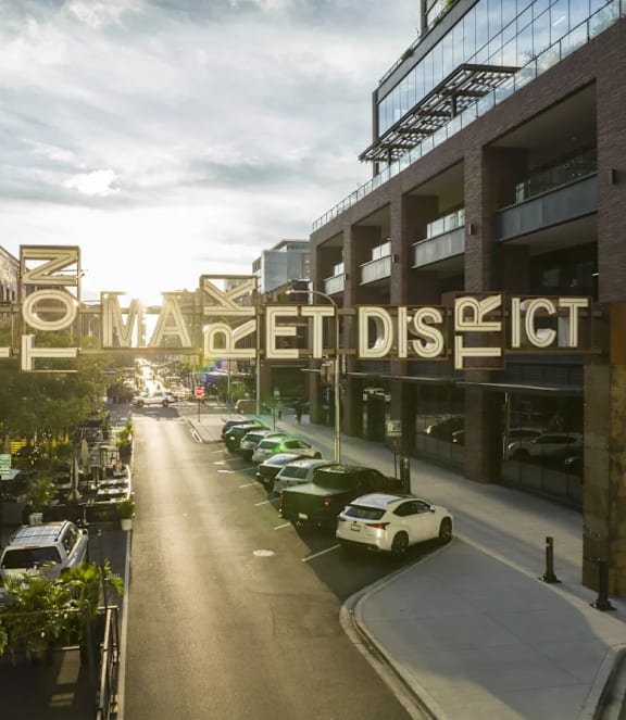 A street view of the Fulham Market District with cars parked on the side.