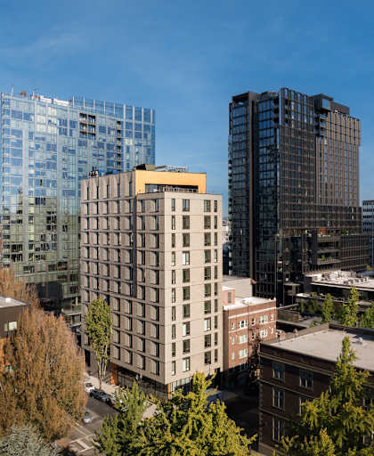 A cityscape with various buildings and trees.