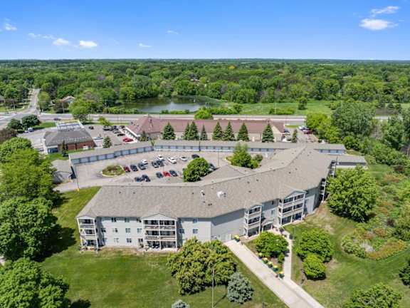 A large building with a parking lot in front of it.