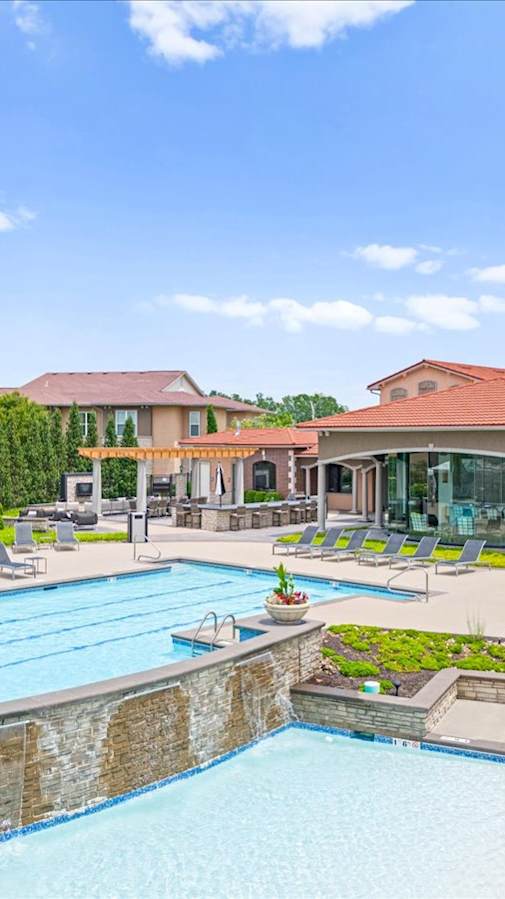 a patio with couches and a fire pit