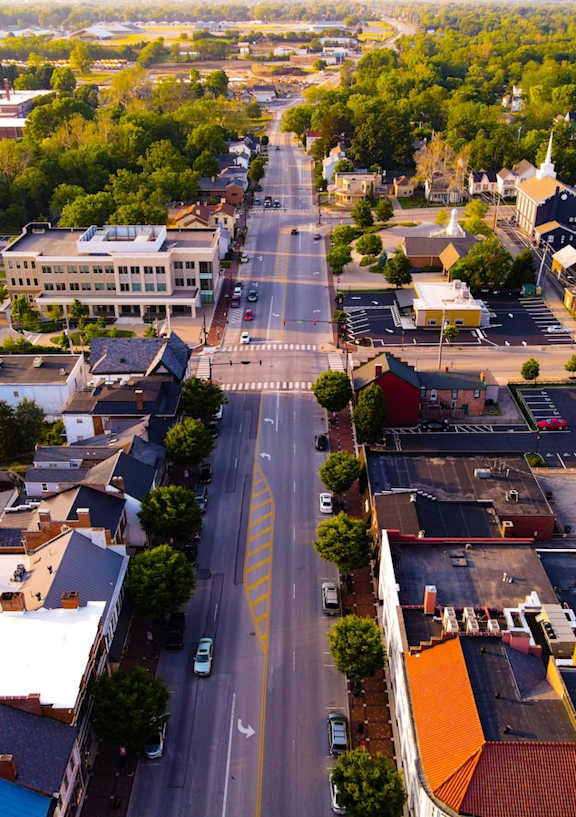 A street view of a small town with buildings on both sides of the street.