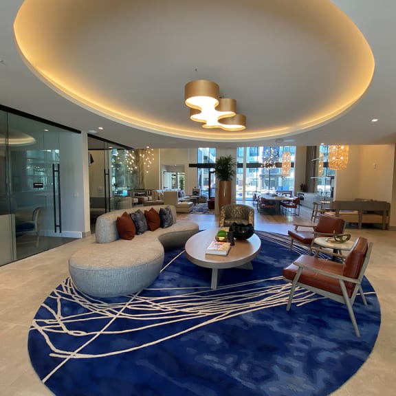 a large living room with a blue rug and furniture at Wildhorse Apartments, Chesterfield, MO