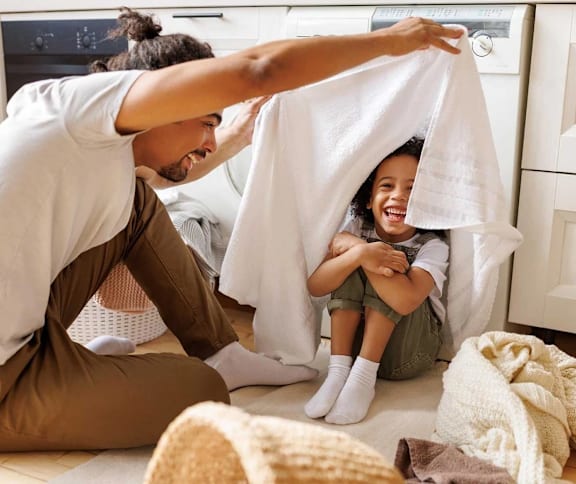 a mother and father playing with their child under a towel at Assembly Park Apartments,Telford, WREKIN TF1 3LE