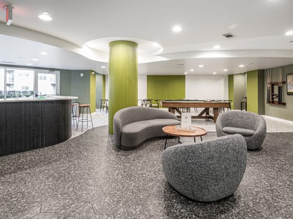 a room with chairs and a table and a bar