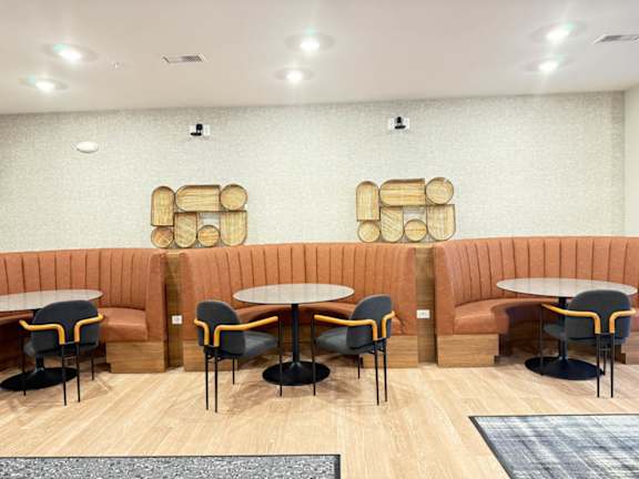 a seating area with tables and chairs in a restaurant