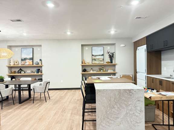 a kitchen and dining area with a table and chairs