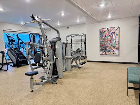 a gym with weights and other exercise equipment in a room