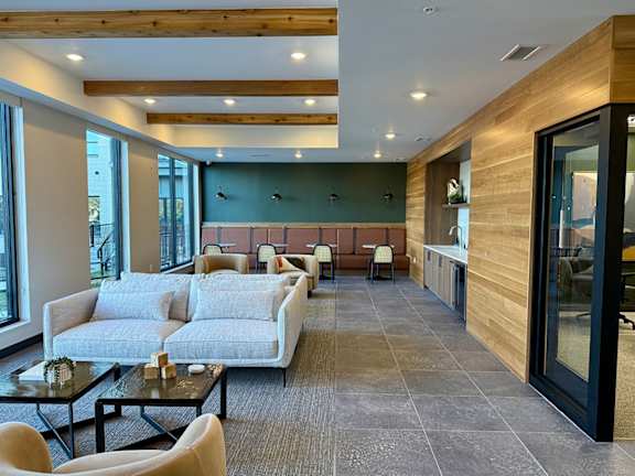 a lounge with couches and chairs and a table