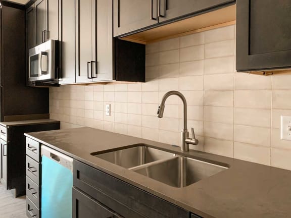 a kitchen with a sink and a microwave