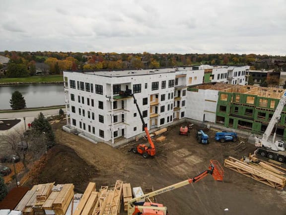 an aerial view of a building being constructed with a crane