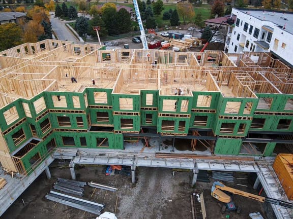 an aerial view of a building under construction with wood framing