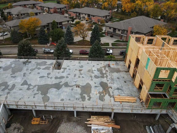 the roof of a building being constructed with wood and scaffolding