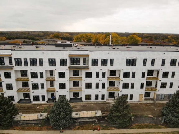 a large white building with trees in front of it