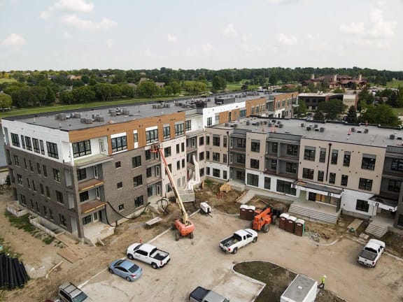 an aerial view of a building being constructed in a parking lot