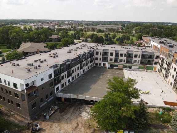 an aerial view of an apartment building with a parking lot