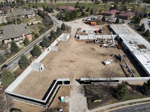 an aerial view of a building in the middle of a parking lot