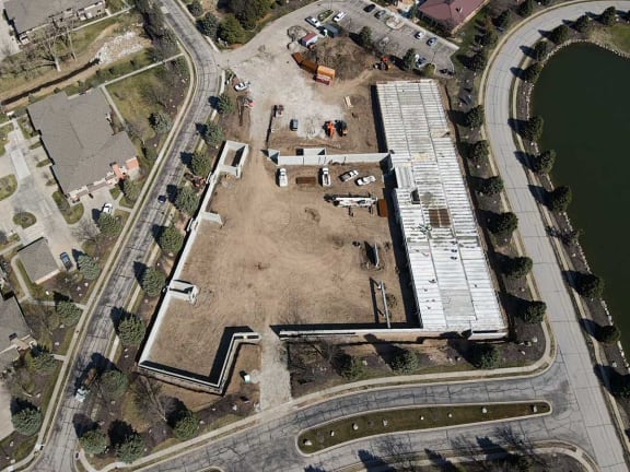 an aerial view of a building site in a parking lot
