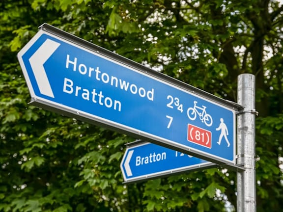 a blue street sign that reads and a street sign