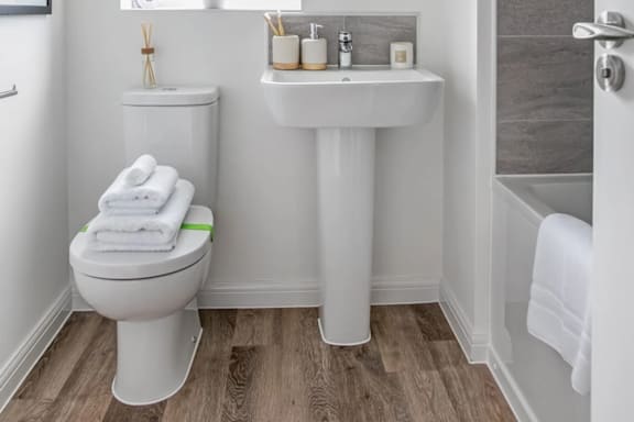 a white bathroom with a toilet and a sink