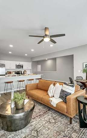 A living room with a white couch and a patterned rug.