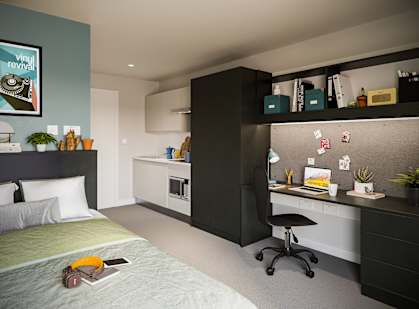 a small bedroom with a bed and a desk