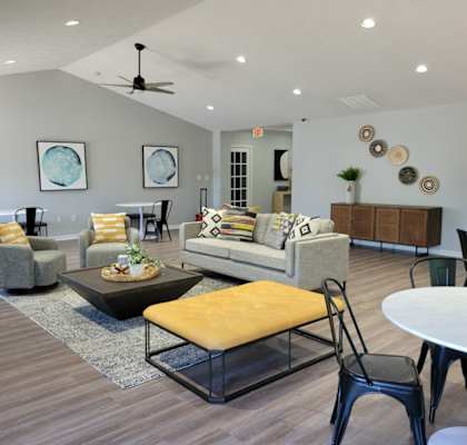 A living room with a couch, chairs, and a coffee table.