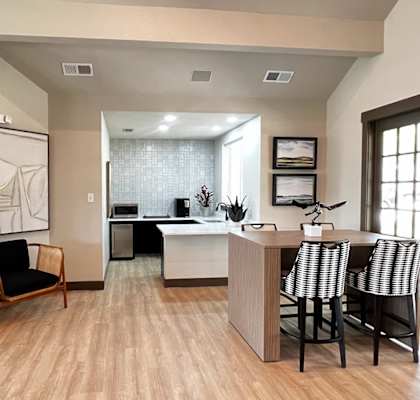 a kitchen and living room with hardwood floors and a large picture on the wall