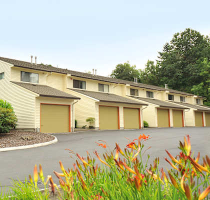 a street view of a yellow building with a parking lot
